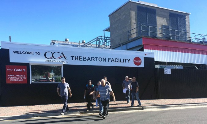 Workers outside the Coca Cola Amatil plant at Thebarton this morning